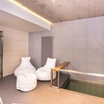 Architectureandinteriordesignofthethree storybuildinginmodernstylewithasaunaandapool